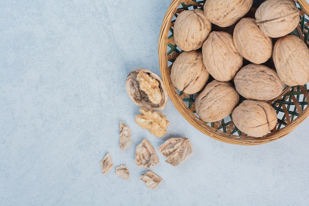 Walnuts and walnut kernels in ceramic bowl. High quality photo