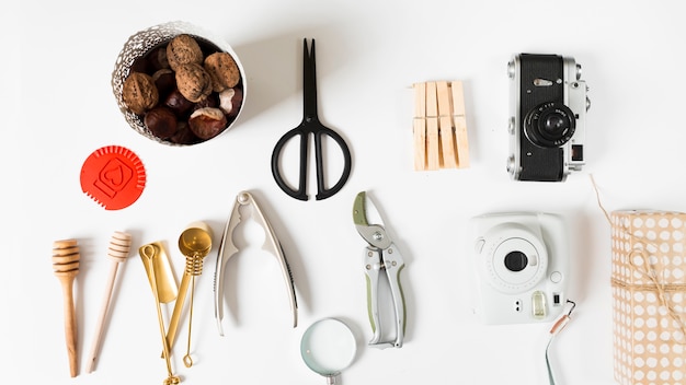 Walnuts with kitchen utensils on table