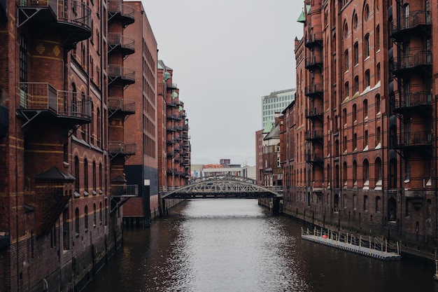 Free photo warehouse district of hamburg bridge among architecture cityscape