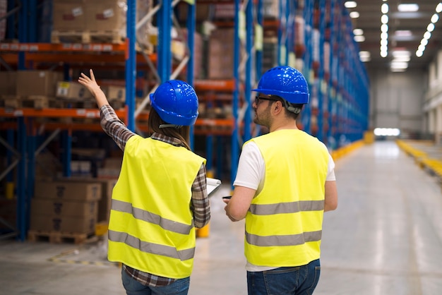 Warehouse workers sharing ideas for better organization and efficiency