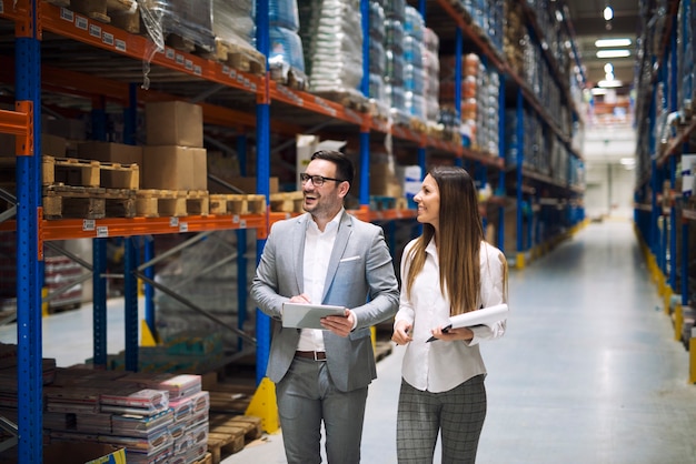 Warehouse workers talking about logistics and distribution