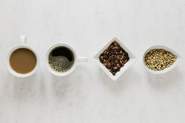 Warm coffee cups on white table