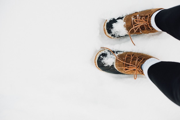 Warm fur boots covered with snow