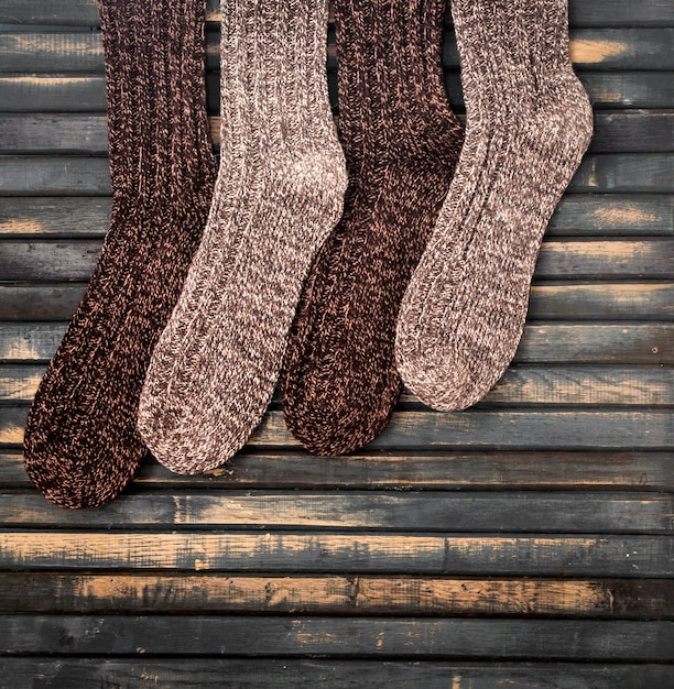 Free photo warm knitted socks on wooden wall