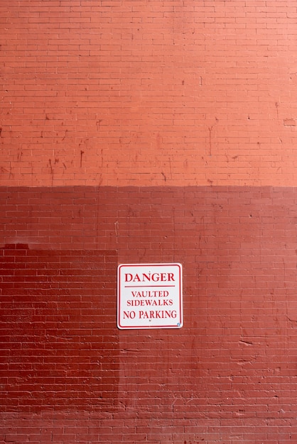 Free photo warning sign on brick wall front view