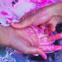 Free photo washing hands in blue liquid