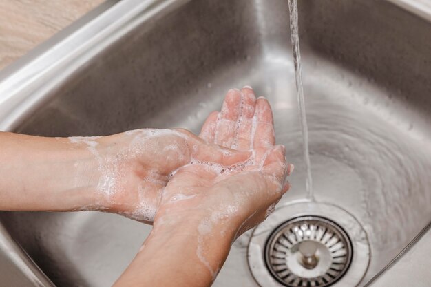 Washing hands rubbing with soap