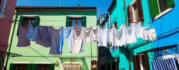 Washing lines with clothes drying in back yard in Burano.