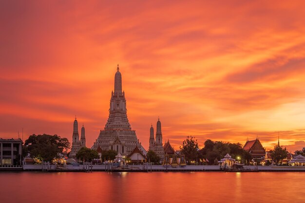 Wat Arun Ratchawararam Temple of Dawn and five pagodas during twilight famous tourist destination in Bangkok Thailand