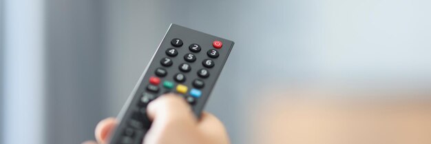 Watching tv and using the remote control concept