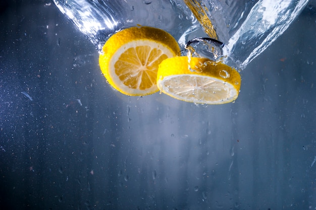 Water background with two lemon slices