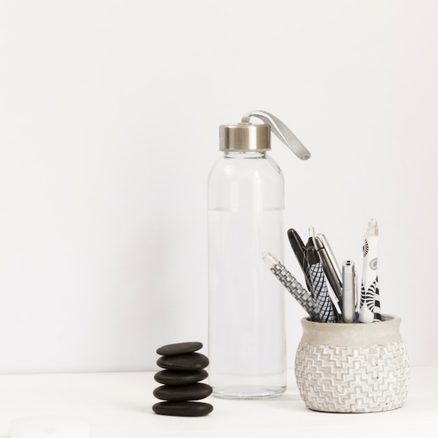 Water bottle with assortment of pens and massage stone 