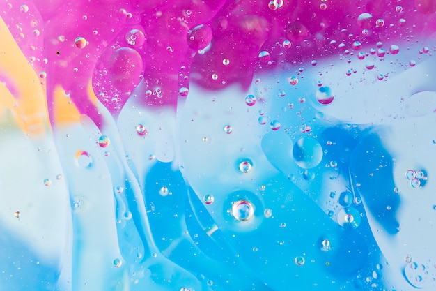 Water bubbles over the blue and pink background