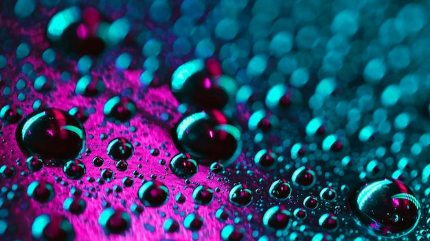 Water bubbles on pink and turquoise surface texture backdrop