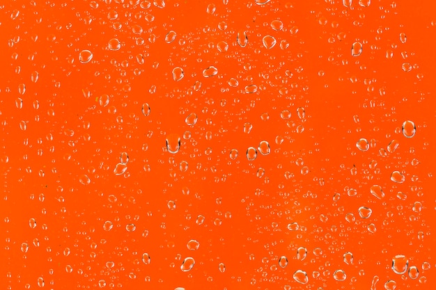 Water droplets on orange surface