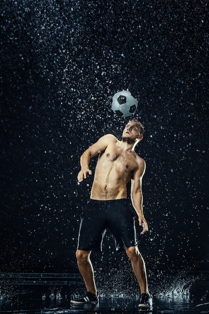 Free photo water drops around football player