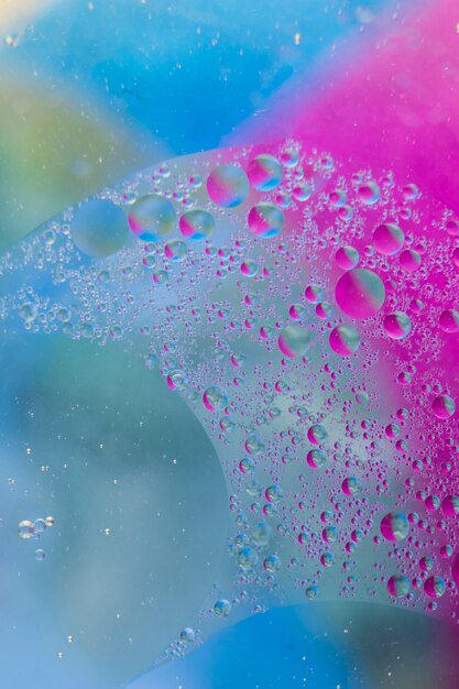 Water drops on the colorful glass surface