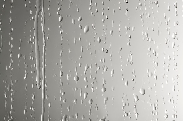 Water drops on a gray wallpaper