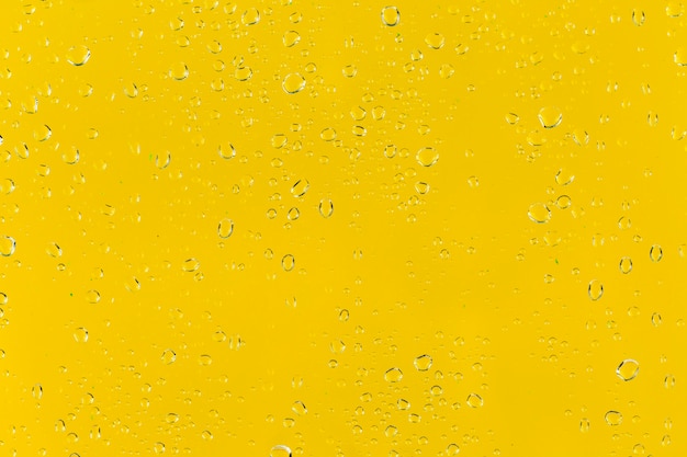 Free photo water drops on yellow surface