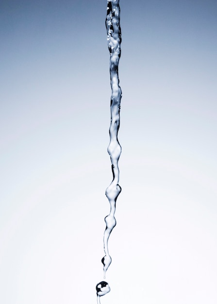 Water flowing on light background