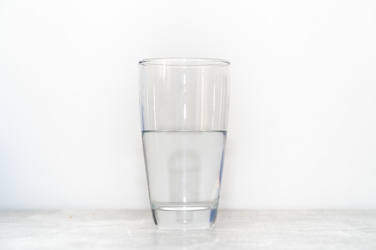 Free Photo a water glass is half filled