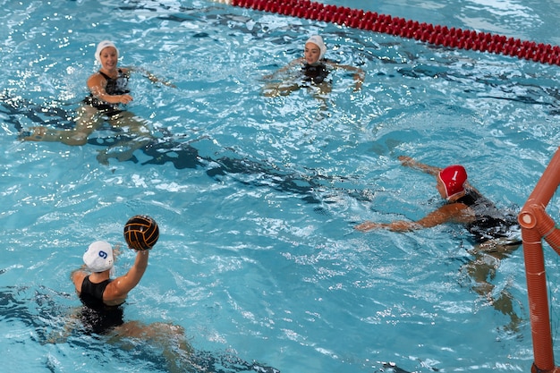 Water polo players at the pool with swimming equipment