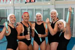 Free photo water polo players at the pool with trophy