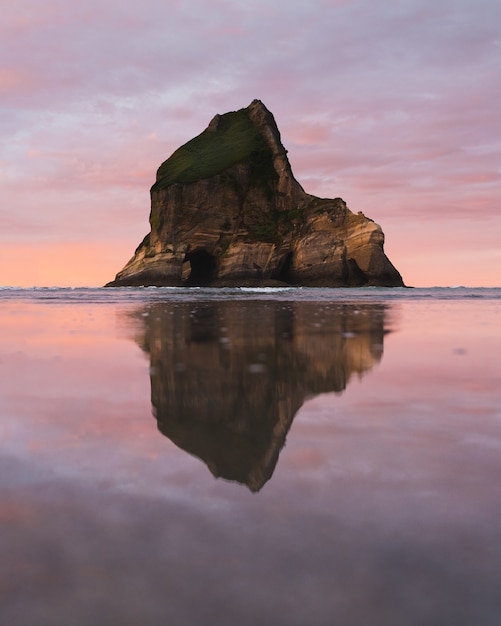 the water reflecting the cliff in the distance