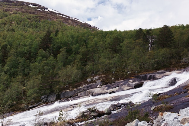 Water runs over the rocks in the mountains 