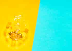 Free photo water splash and bubbles on yellow and blue background