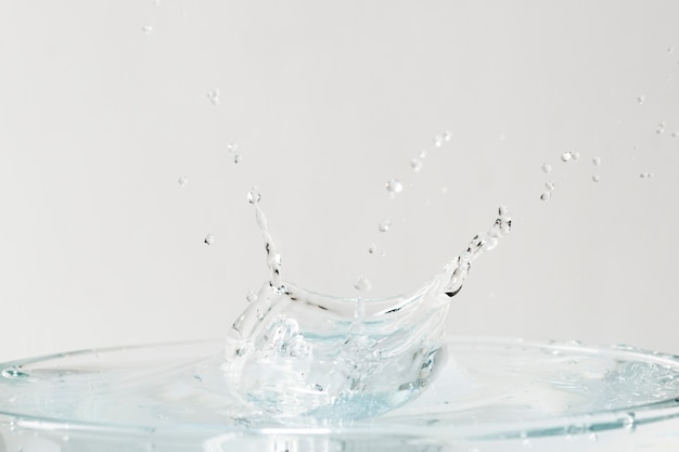 Water splash on top of the glass background wallpaper