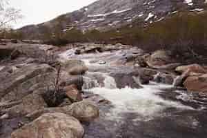 Foto gratuita l'acqua schizza contro le rocce sul fiume