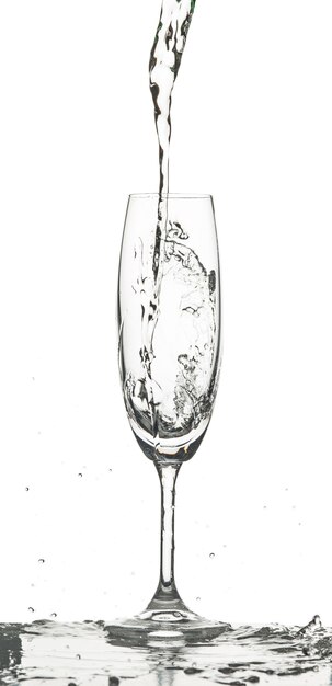 water splashing into glass on white background