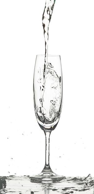 water splashing into glass on white background