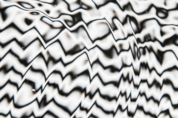 Water waves on a black and white pool surface