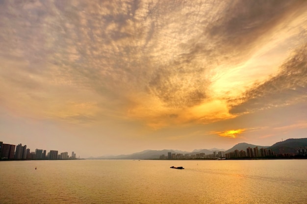 Free photo water with yellow clouds