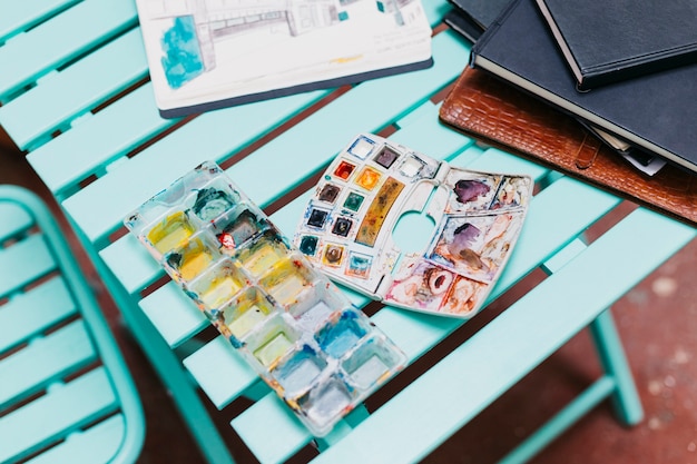 Watercolor and sketchbooks on table