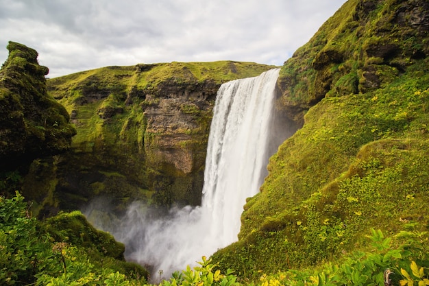 Free photo waterfall between green mountains