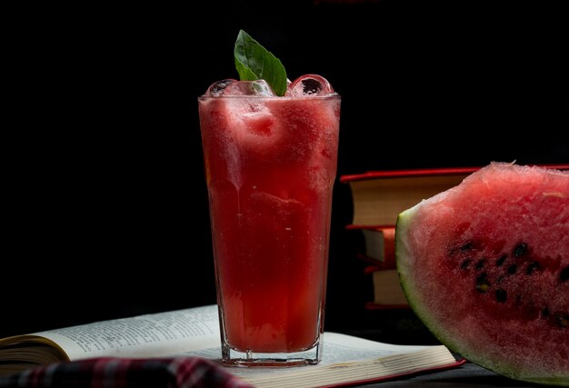 Watermelon ice cold smoothie with mint leaves and a slice of watermelon