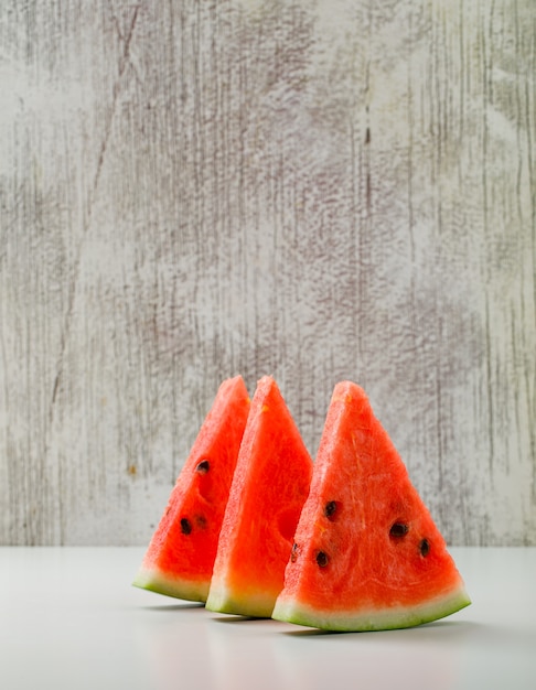 Watermelon slices on white and grunge background. side view.