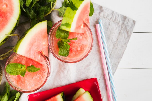 Watermelon smoothies and straws on napkin