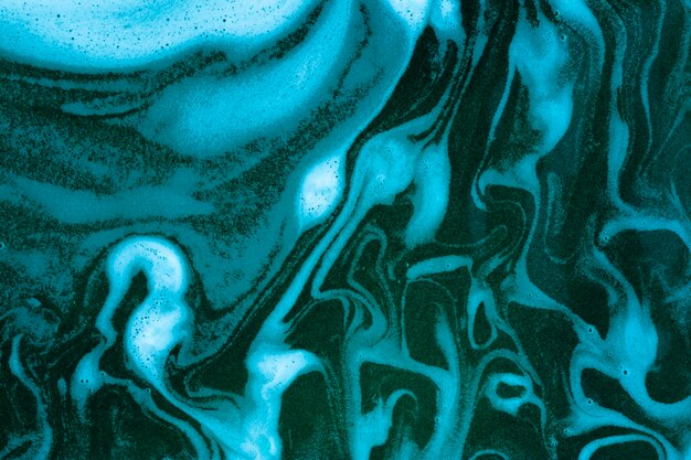 Waves on foam on blue colored liquid