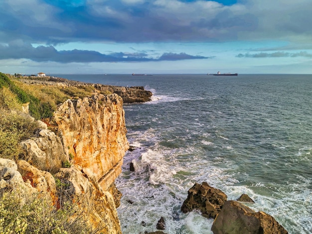 Waves hitting rocks in Cascais beach