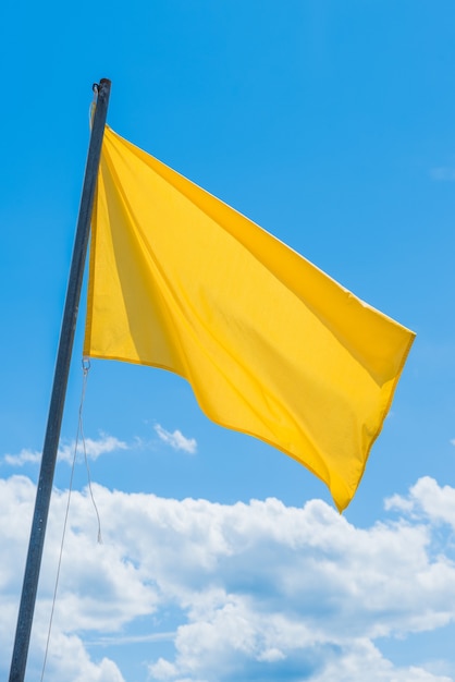 Waving green flag indicating the potentially high surf at the beach