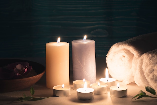 Free photo wax illuminated candles with spa wellness setting on table