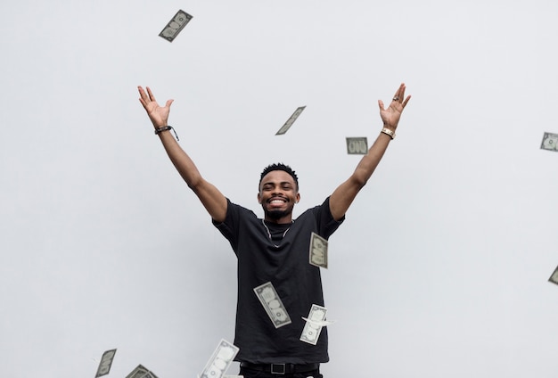 Free photo a wealthy african man throwing away his money