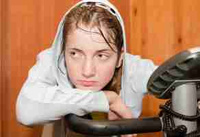 Free photo weariness girl on exercycle