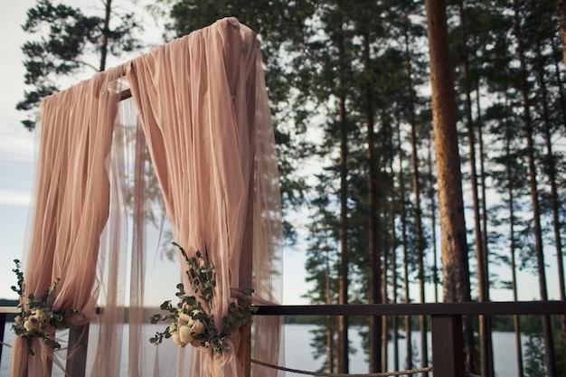 Wedding altar made of pink cloth and roses