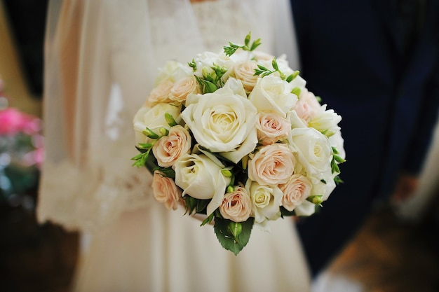 Wedding bouquet on hands of bride