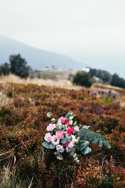 Free photo wedding bouquet lies on the grass